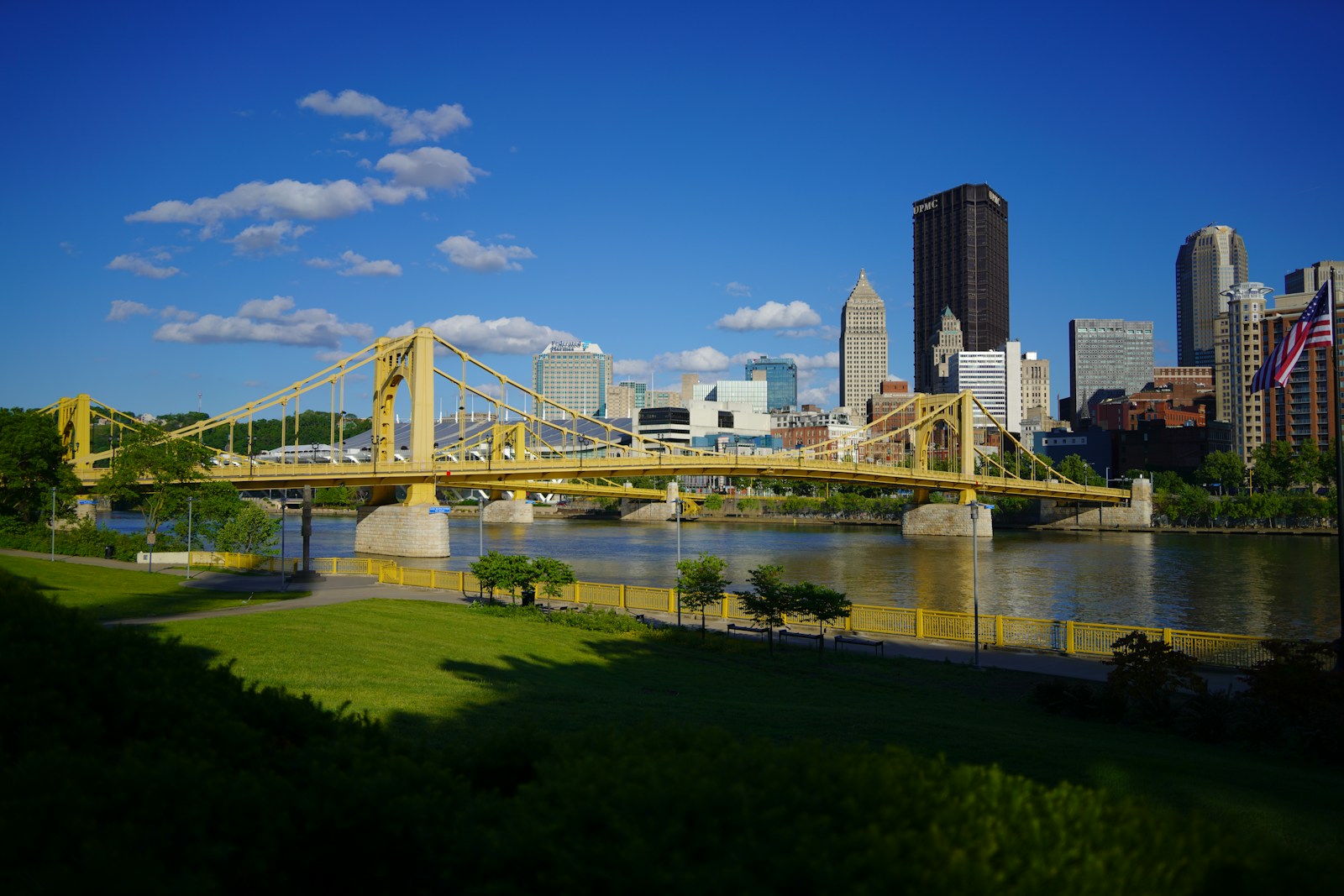 A bridge over a river with a city in the background